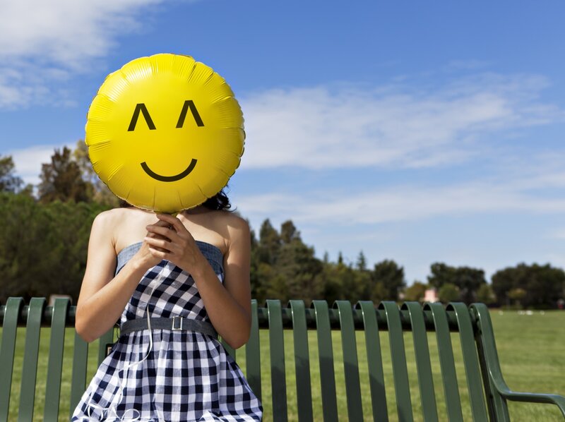 Woman Holding Balloon — Yellow