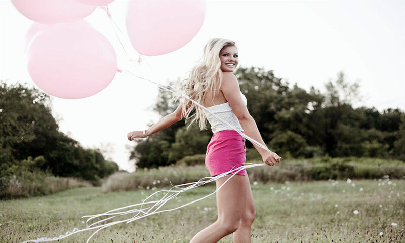 Woman Holding Balloons — Pink, Playful