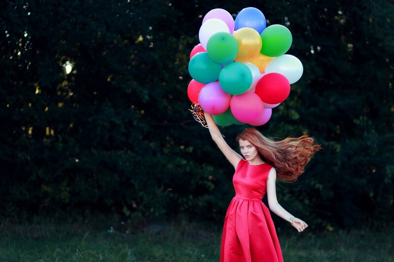 Woman Holding Balloons — Red, Dramatic, Sunset