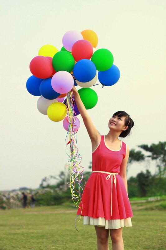 Woman Holding Balloons — Red, Joyful