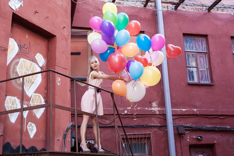 Woman Holding Balloons — Red, Playful