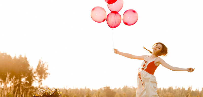 Woman Holding Balloons — Red, Serene, Sunset