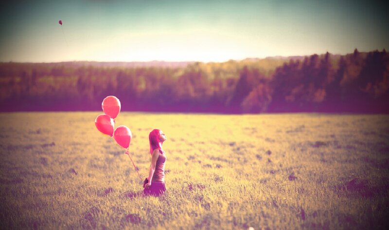 Woman Holding Balloons — Yellow, Serene