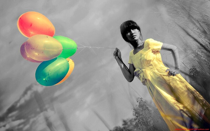Woman Holding Balloons — Yellow