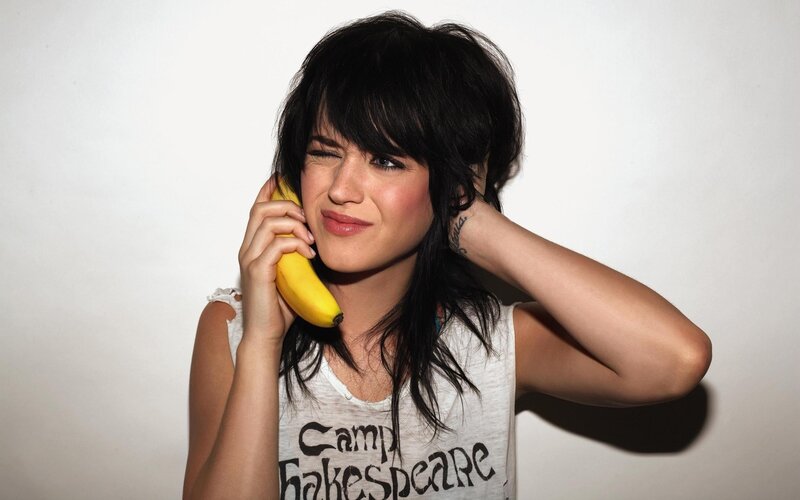 woman holding banana to ear