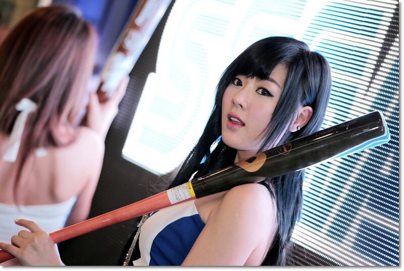 Woman holding baseball bat at event