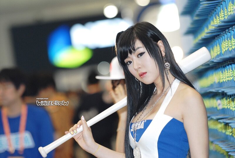 woman holding baseball bat at event