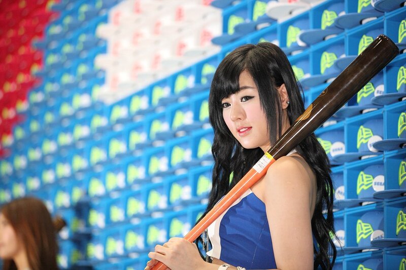 Woman holding baseball bat at stadium