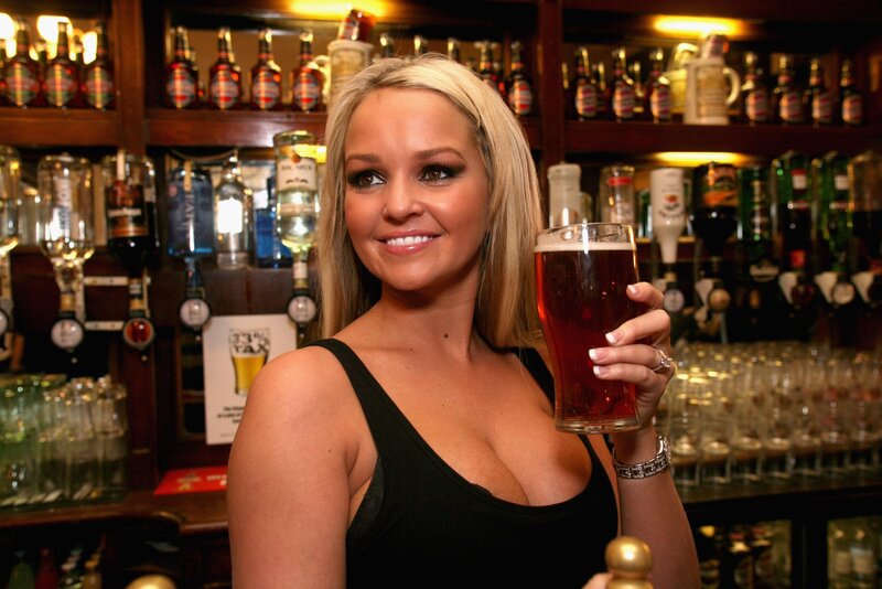Woman holding beer at bar