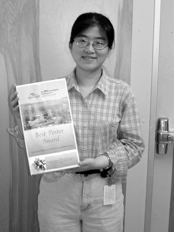 Woman holding best poster award