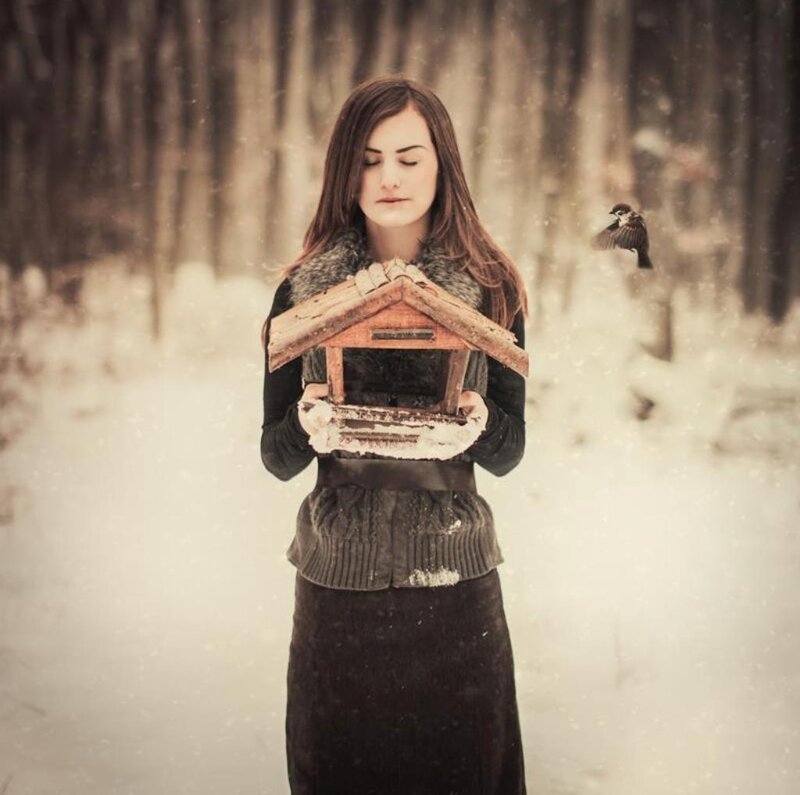 Woman Holding Bird Feeder