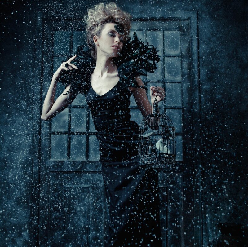 Woman Holding Birdcage — Black, Dramatic, Winter