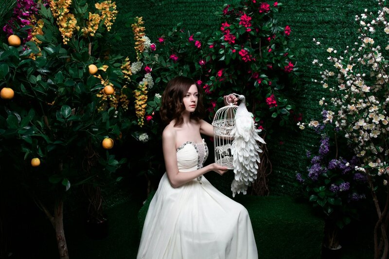 Woman Holding Birdcage — White, Dramatic