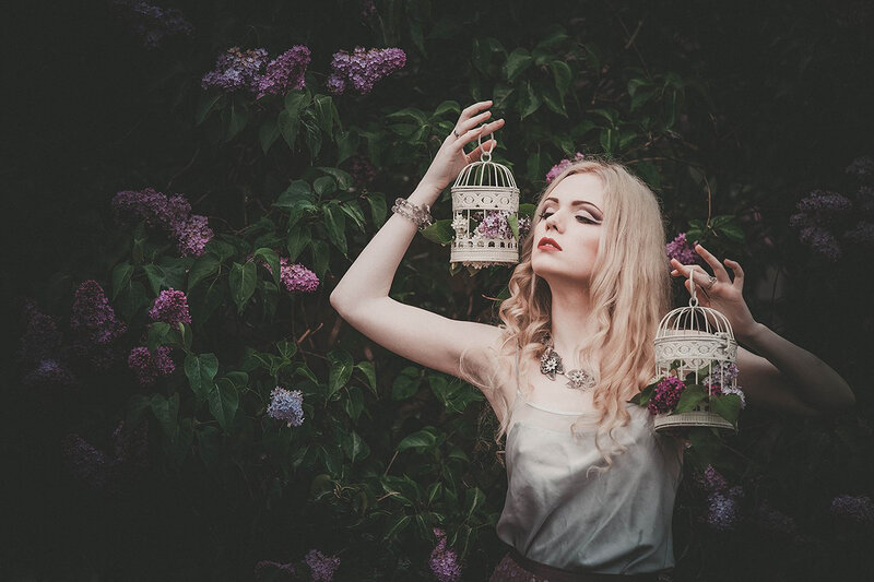 Woman Holding Birdcages