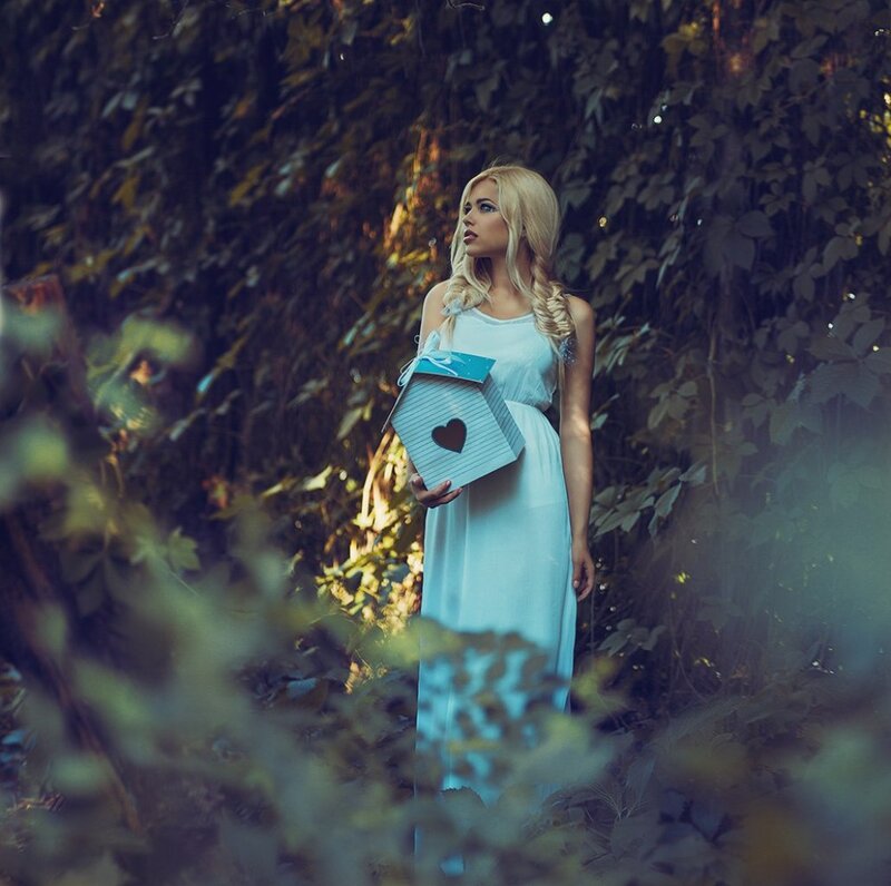 Woman Holding Birdhouse