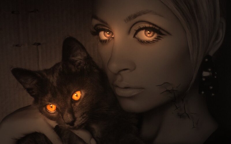 woman holding black cat
