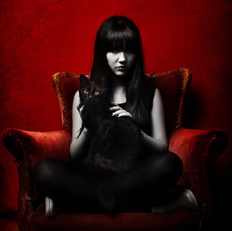 Woman Holding Black Cat — Red