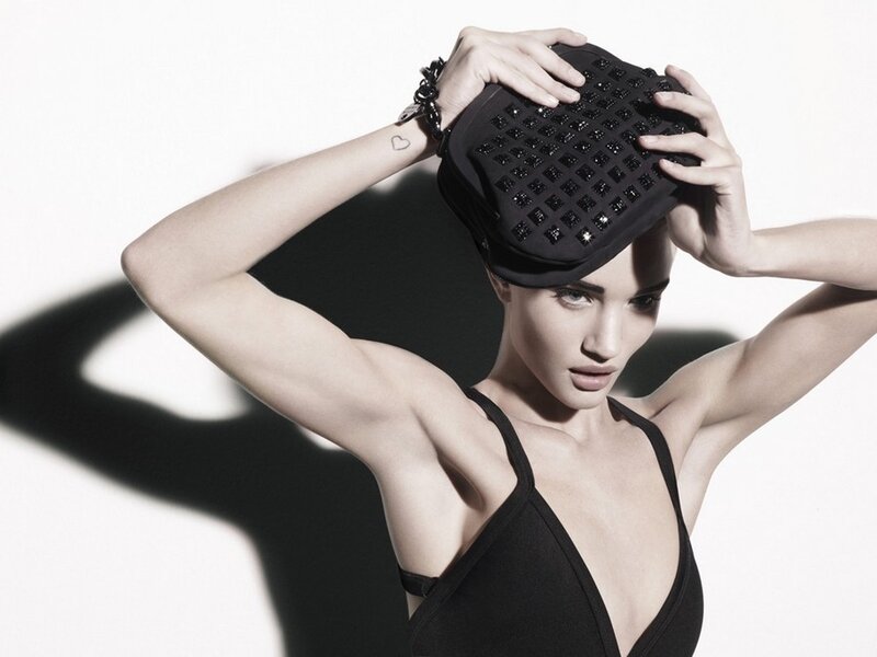 woman holding black clutch