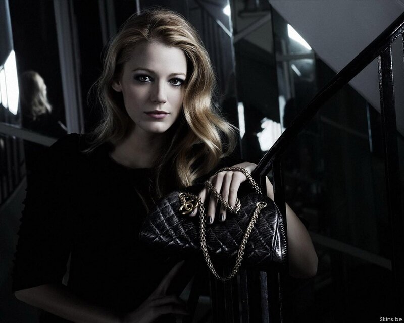 woman holding black handbag