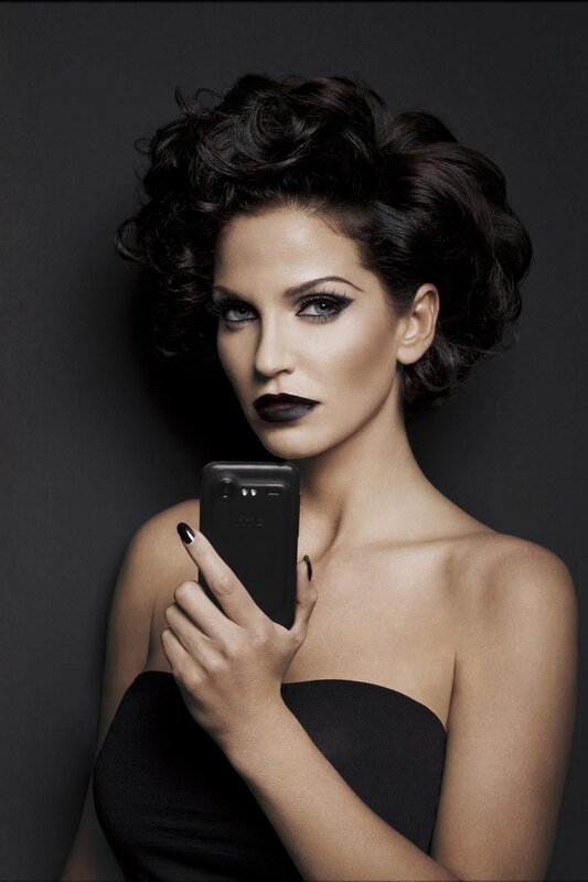 woman holding black phone