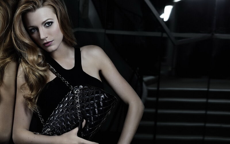 Woman Holding Black Purse — Dramatic