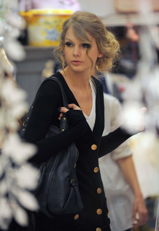 woman holding black purse