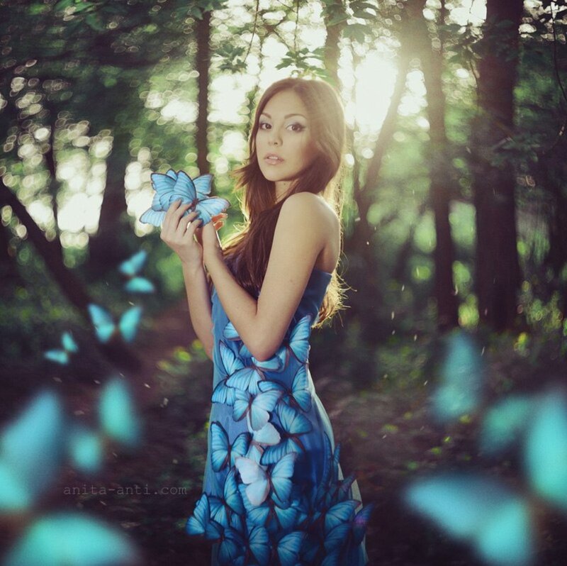 Woman Holding Blue Butterflies