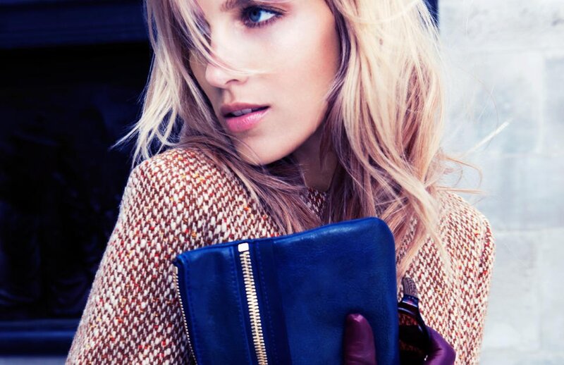 woman holding blue clutch