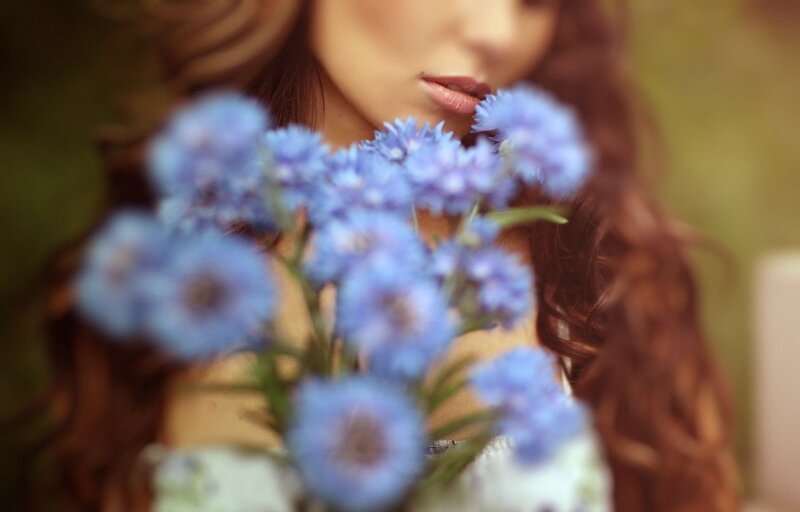Woman Holding Blue Flowers