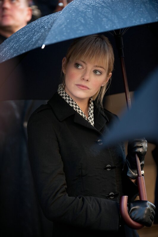 woman holding blue umbrella