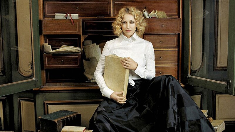 woman holding book in library