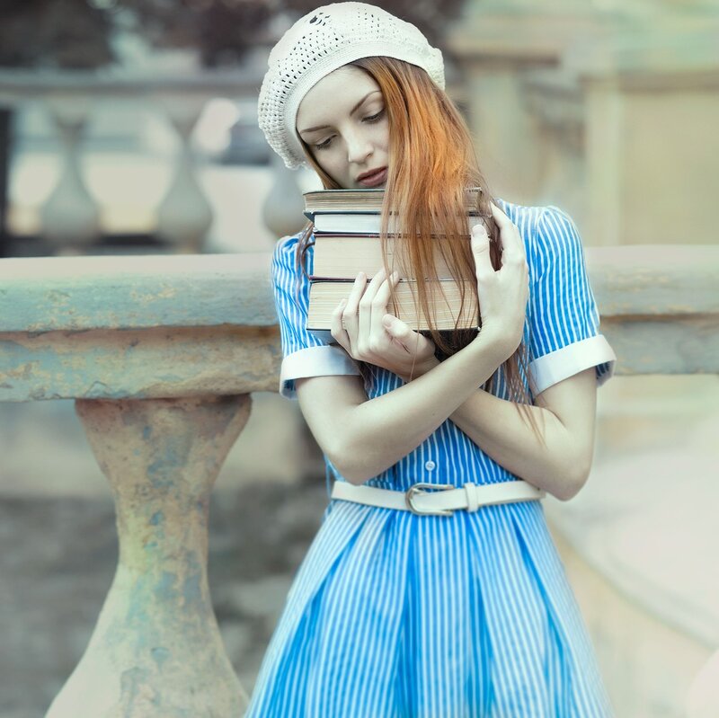 Woman Holding Books — Blue