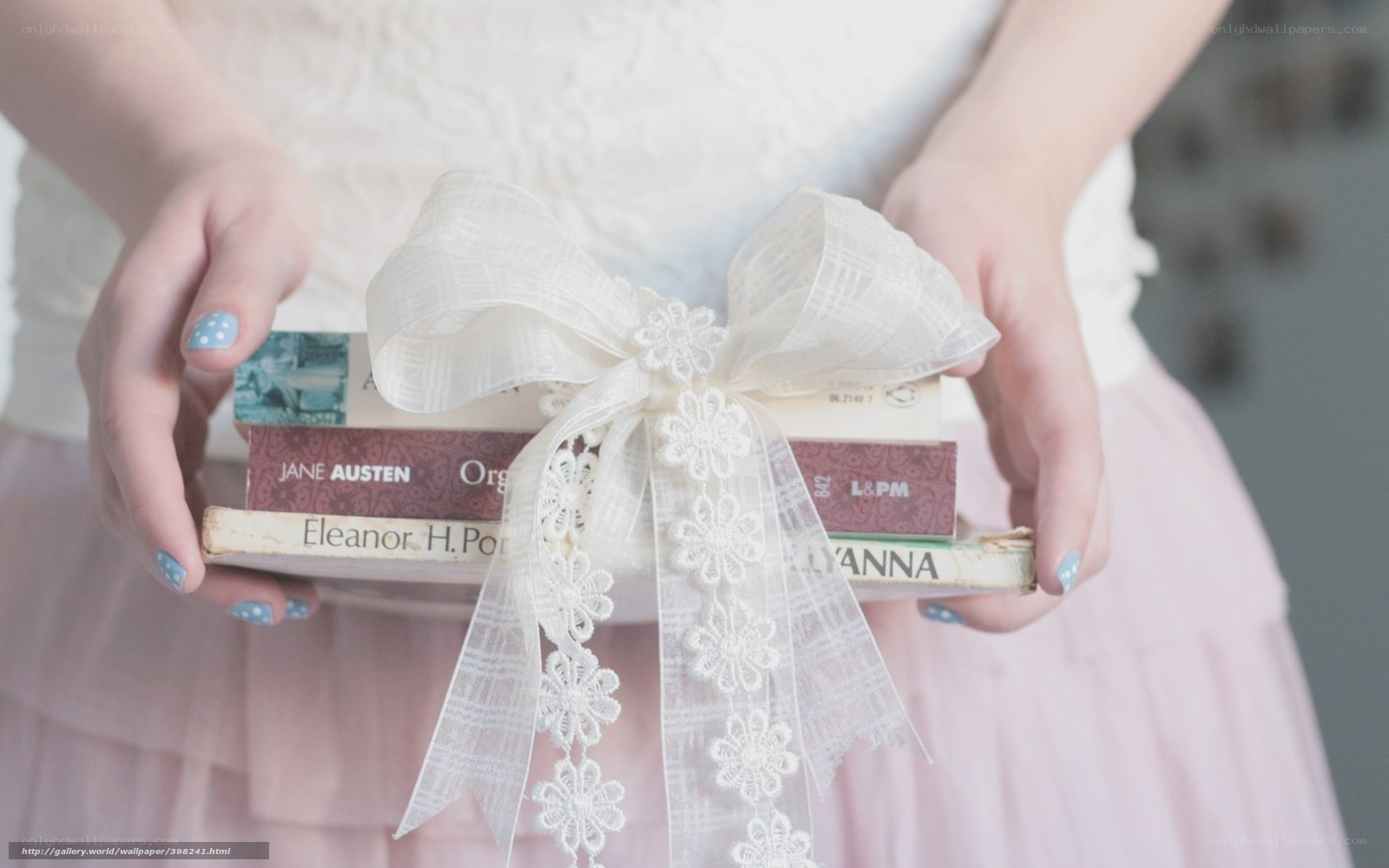 woman holding books with ribbon