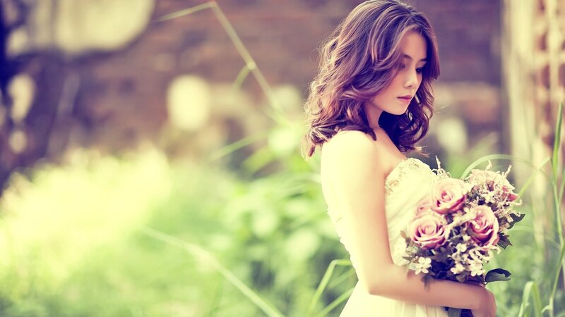 woman holding bouquet outdoors