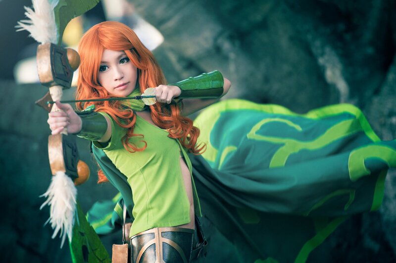 Woman Holding Bow — Green, Dramatic, Photograph