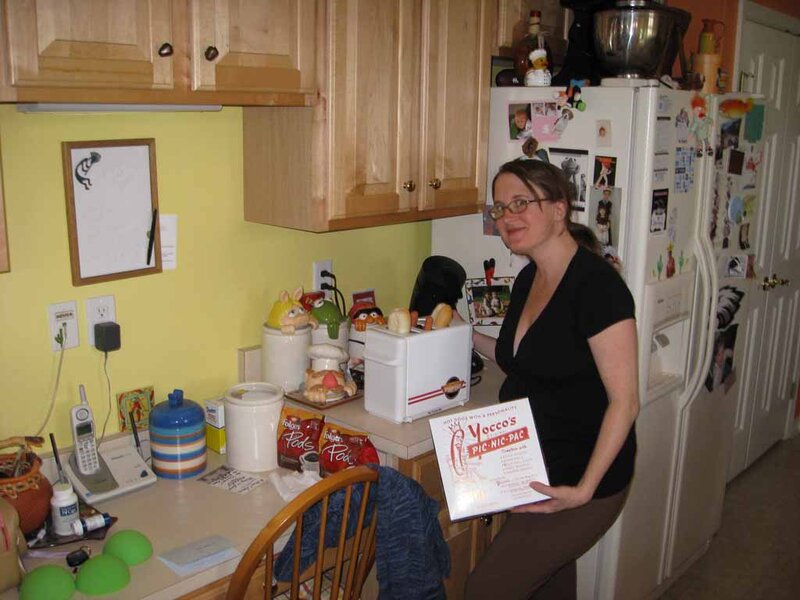 Woman Holding Box in Kitchen