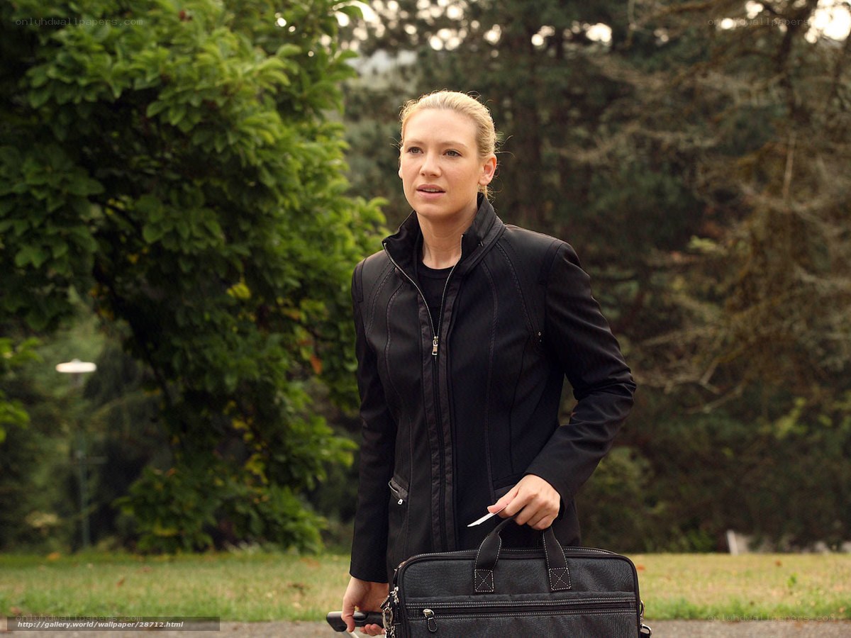 woman holding briefcase in park