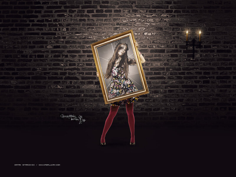 woman holding broken mirror