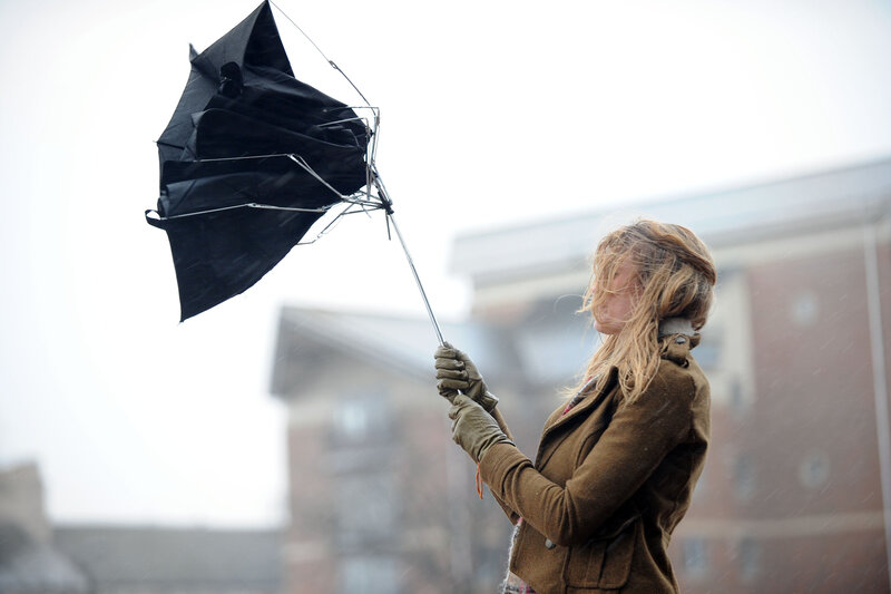 Woman Holding Broken Umbrella