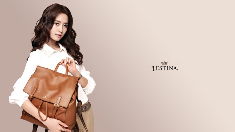 woman holding brown bag