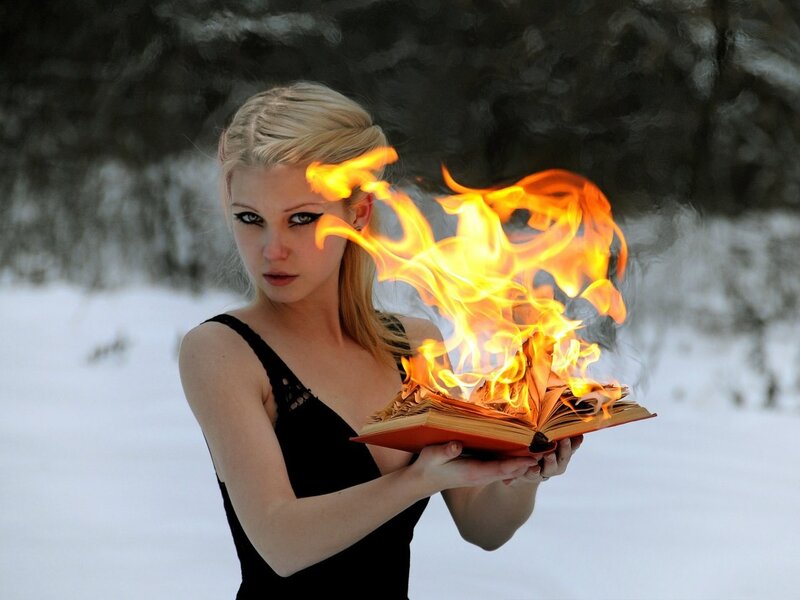 woman holding burning book