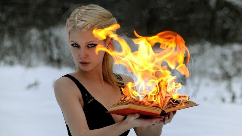 woman holding burning book