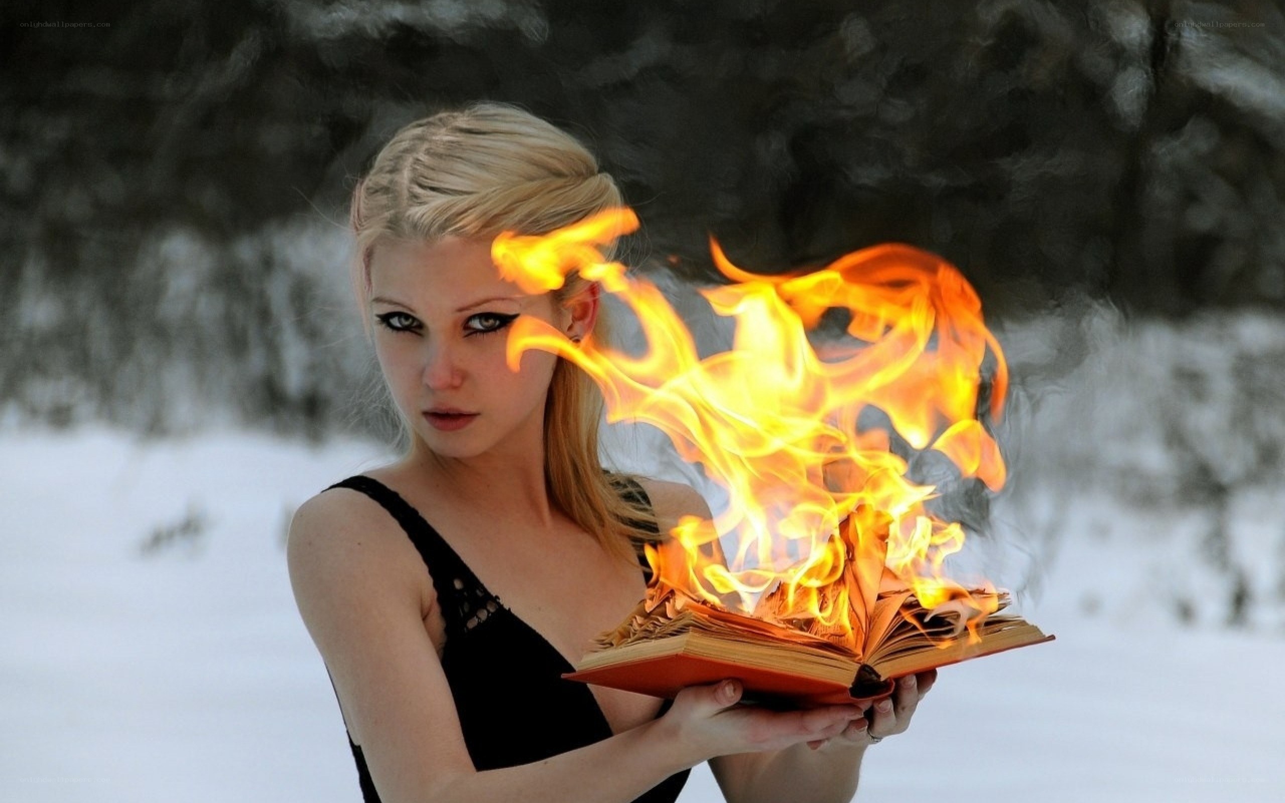 woman holding burning book