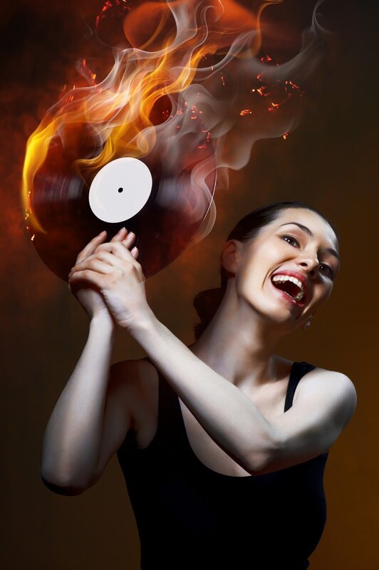woman holding burning record