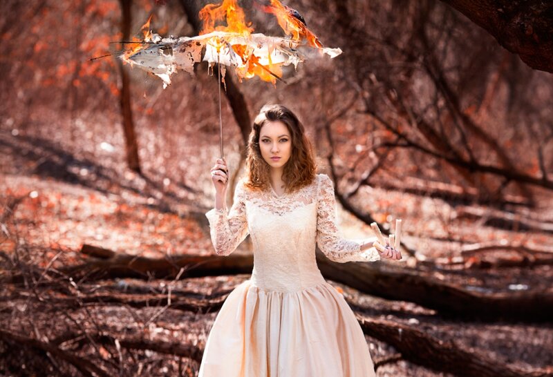Woman Holding Burning Umbrella