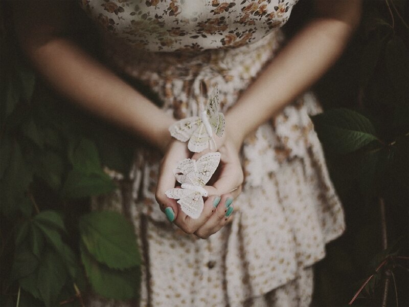 Woman Holding Butterflies — White