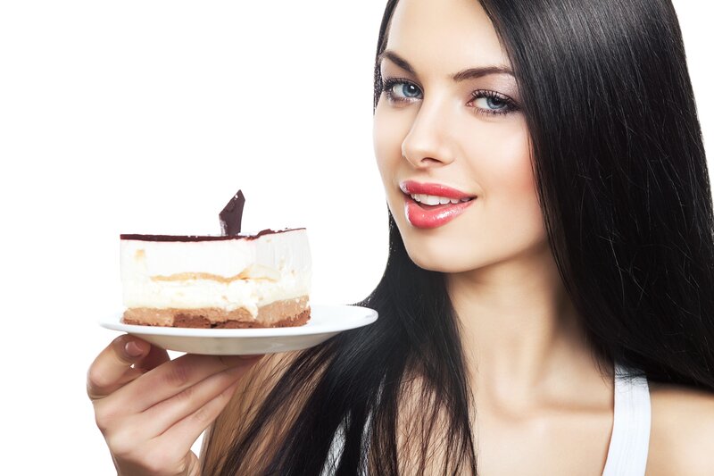 woman holding cake slice