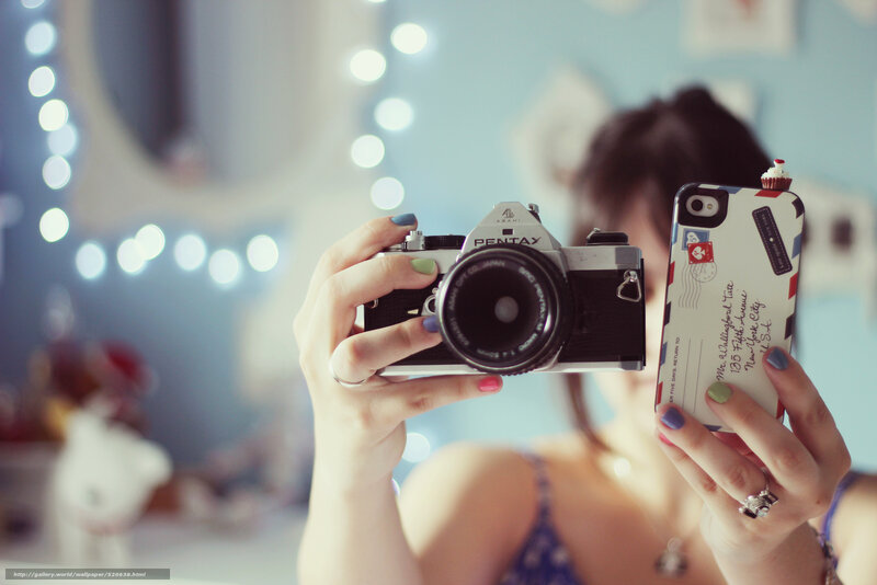 woman holding camera and phone