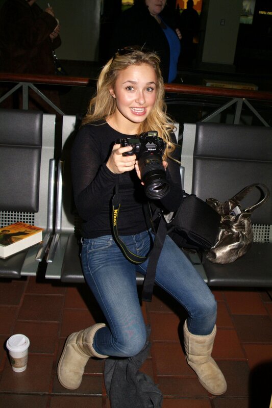 woman holding camera at airport