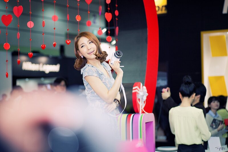 Woman holding camera at event